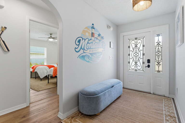 Walk through the door and the property sets the tone immediately — the coastal mural in the foyer welcomes your whole crew.