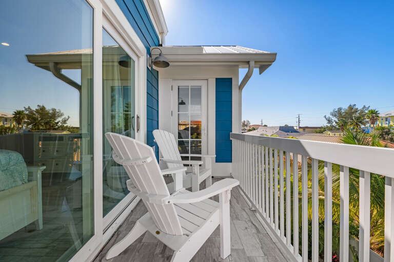 Claim an Adirondack chair up here and just watch the neighborhood wake up — coffee first, everything else later.