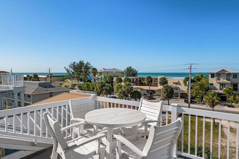 Take your coffee up to the balcony and watch the Gulf wake up over the rooftops — this is the view you'll be chasing all week.