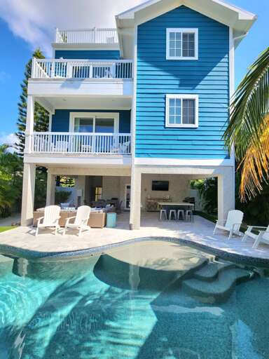 Take in three floors of beach house — built tall to catch every Gulf breeze and sized to keep sixteen people comfortable without anyone feeling crowded.