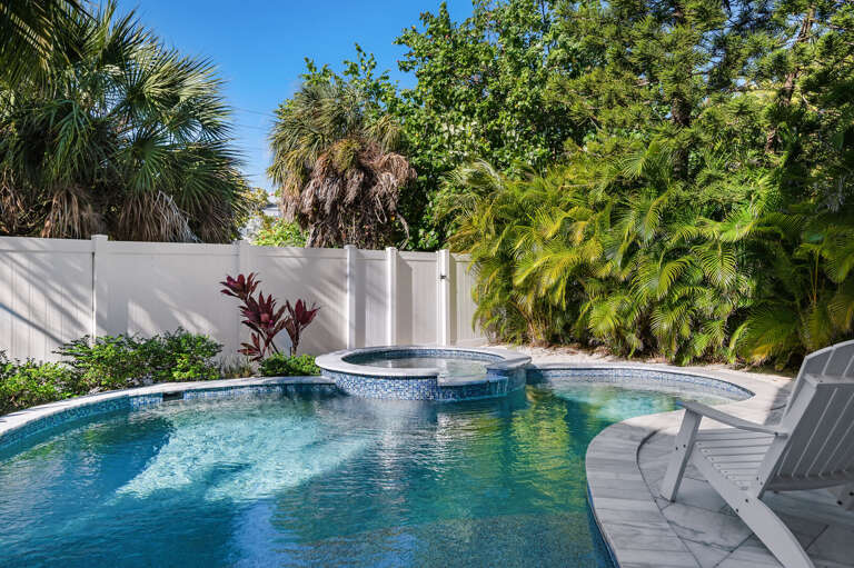 Slide into the spa right at eye level with the palms — one lounge chair already waiting for whoever gets there first.