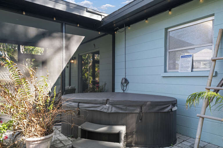 Ease in after a full day at the beach — the hot tub stays warm and the screened lanai keeps the evening quiet.