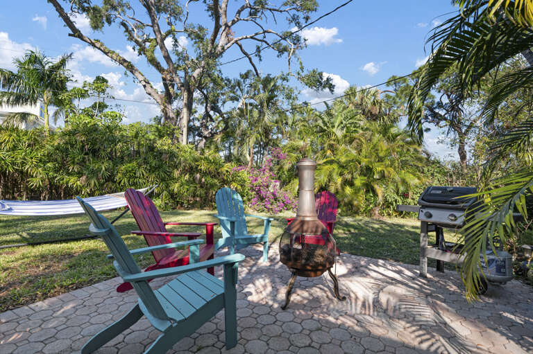 Fire up the Weber, pull the chairs in tight, and let the evening happen around the fire pit — this is the outdoor setup guests come back for.
