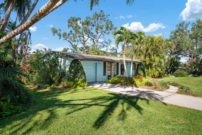 Walk the perimeter once — the towering palms make the whole yard feel a world away from the road.