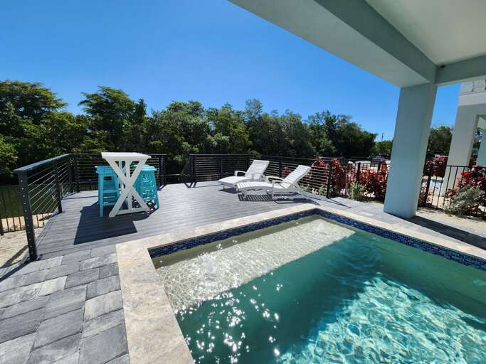 Float on your back in the pool and watch the boats drift along the canal just beyond you.