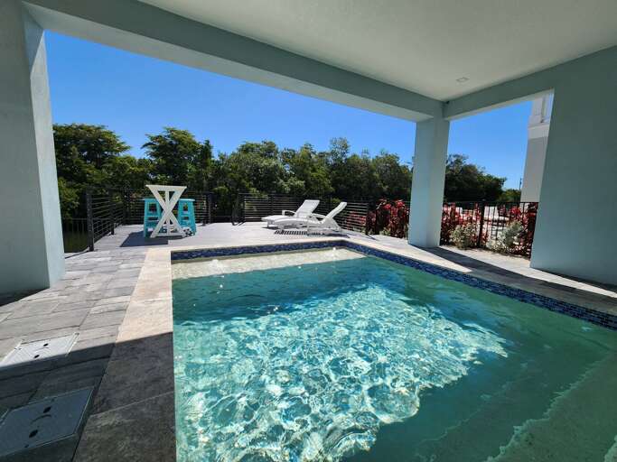 Grab the shade of the covered patio when the sun gets to be too much and keep an eye on your kids in the pool anyway.