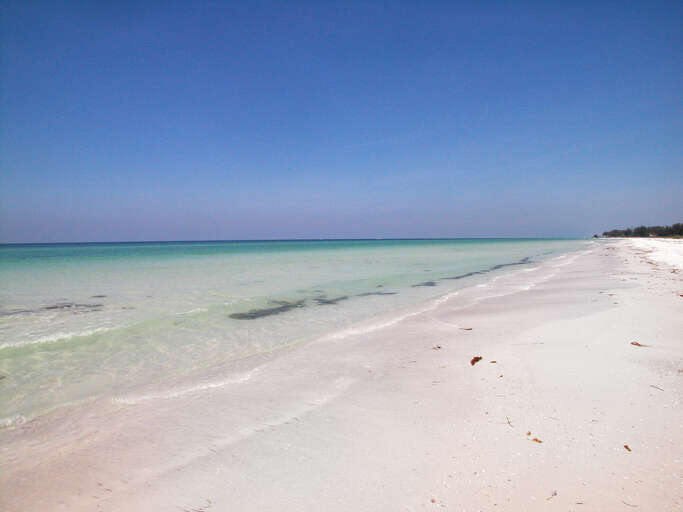 Picture this turquoise water waiting for you before anyone's set up a single umbrella.