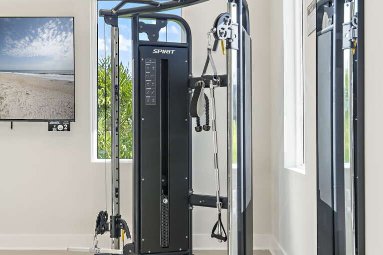 Sneak in one more set on the community gym's cable machine before your group's ready to head to the beach.