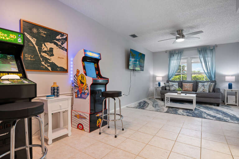 2nd living room, with packman and golden tee games, Overlooks the pool, this living room offers a pull out couch.