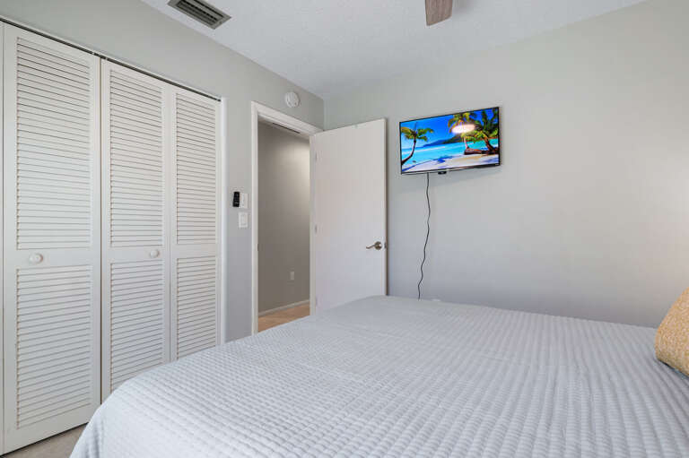 Bedroom two offers a queen size bed with a TV.