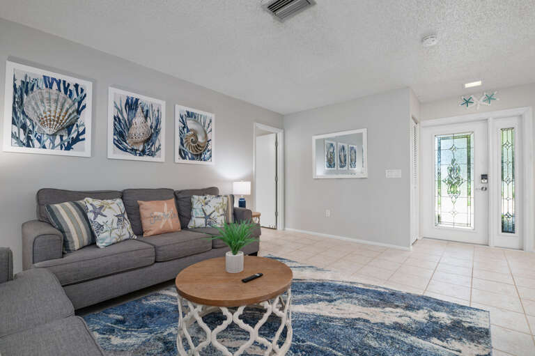 Living room overlooks the patio and is right outside the master bedroom, this living room offers a sleeper sofa and large tv.