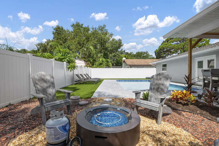Your call: fire pit or pool? Both share the same backyard — the kids can be in the water while the adults warm up by the fire.