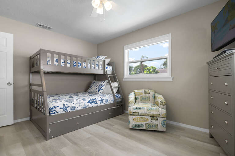 Claim the armchair corner or stack the trundle — the bunk room keeps the beach vibes going long after sunset.