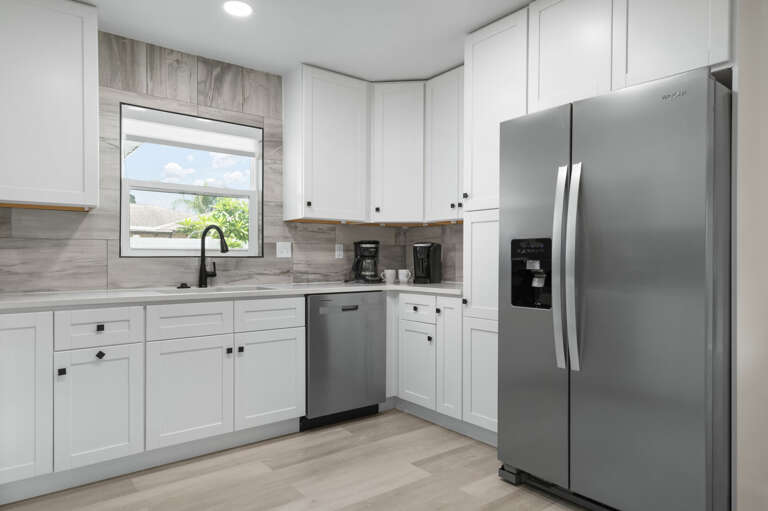 Cook a real breakfast without fighting the counter space. White shaker cabinets, full-size stainless appliances, and a kitchen that was designed to actually be used.