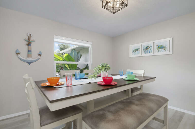 Your dining setup arrives with personality — anchor art, colorful place settings, and room for the whole group. Breakfast here sets the tone for the day.