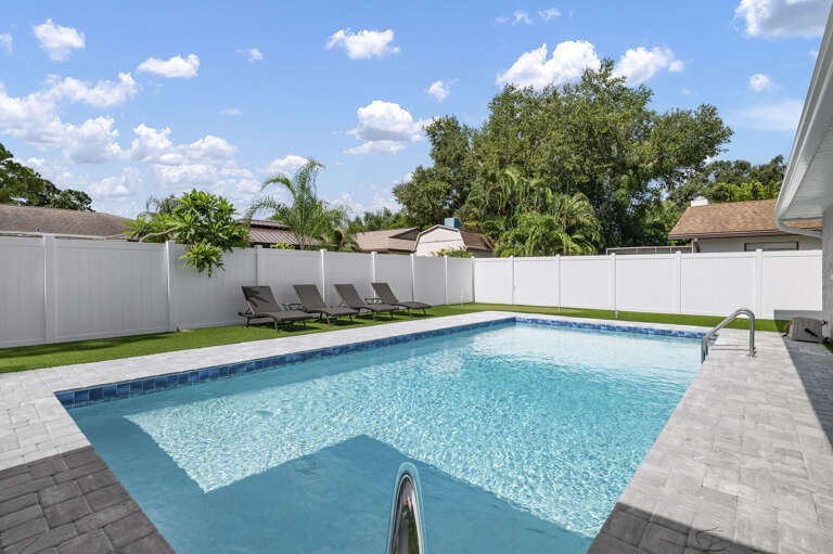 Grab a lounger, sunscreen up, and let the palms do their job — the pool deck stays exactly this laid-back all day long.