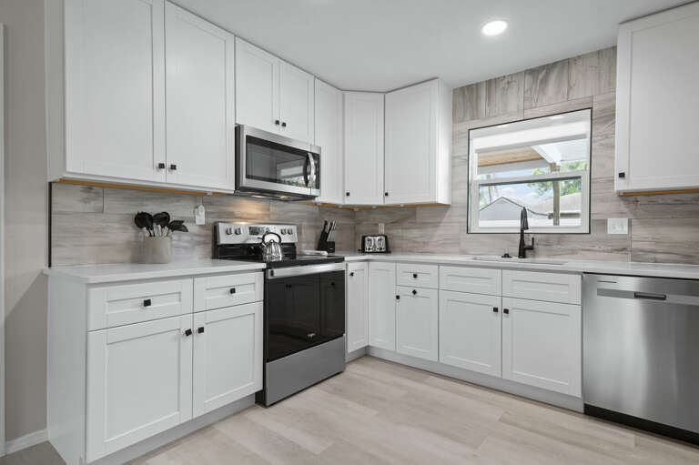 Your kitchen is fully loaded — full range, built-in microwave, marble tile backsplash. Everything you need for real meals, not just reheating takeout.
