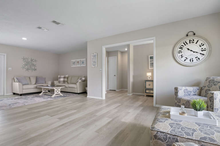 You'll notice the details without looking for them — coastal accents, a statement clock, two seating zones. Someone put real thought into this room.