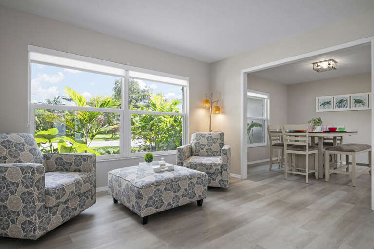 Your morning starts here first — the sitting area catches the light early, the coffee setup is steps away, and the ocean art makes it feel unhurried.