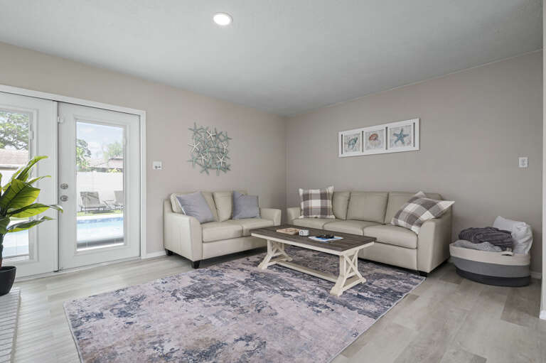 Your move — settle into the sectional, crack the French doors, and watch the pool shimmer just outside while everyone finally unwinds.