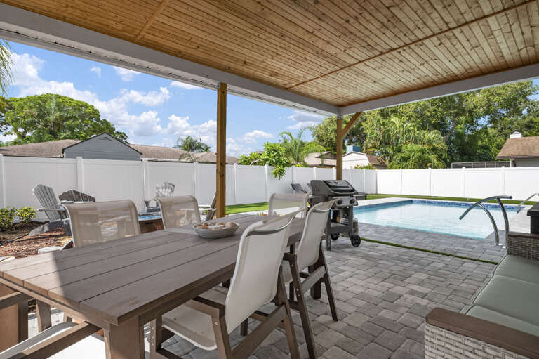Pull every chair to the table, light the grill, and let dinner stretch until dark. The covered patio has room for the whole group and then some.