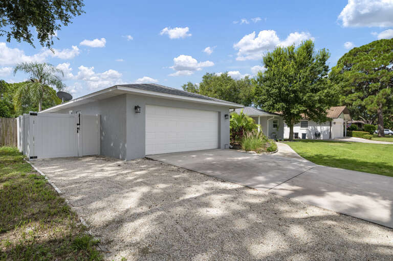 Pull in, unload, and you're inside in one trip — two-car garage, wide concrete driveway, and a single-story layout that makes arrival genuinely easy.