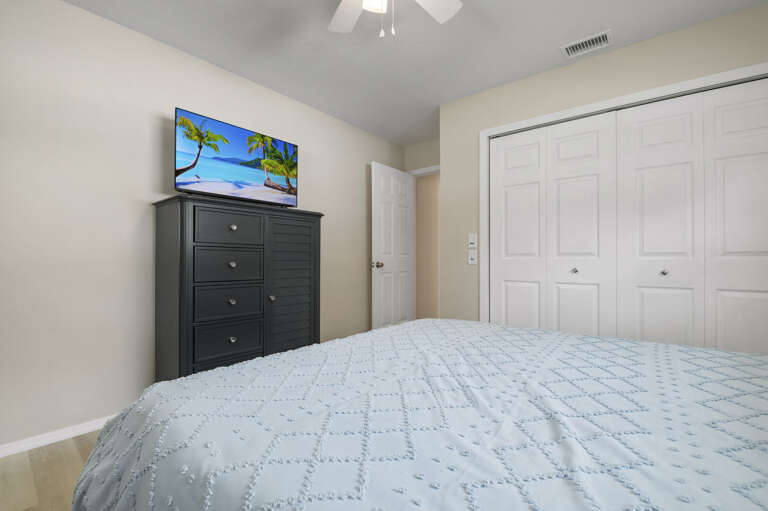 Your second queen room — sliding closet, wall-mounted TV, and everything you need for a good night. Simple, well-appointed, and easy.