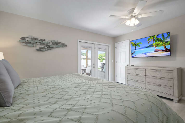 Your room has direct pool access — throw open the French doors, let the outside in, and decide between a movie in bed or a morning swim.