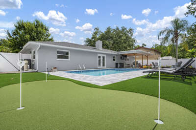 Step into the backyard and get it all — sparkling pool, putting green, and lounge chairs in the Florida sun. This is the afternoon you came for.