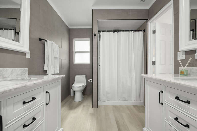 Step into the walk-in shower, use the private toilet alcove, and head back to the king — the primary suite handles the whole morning routine right.