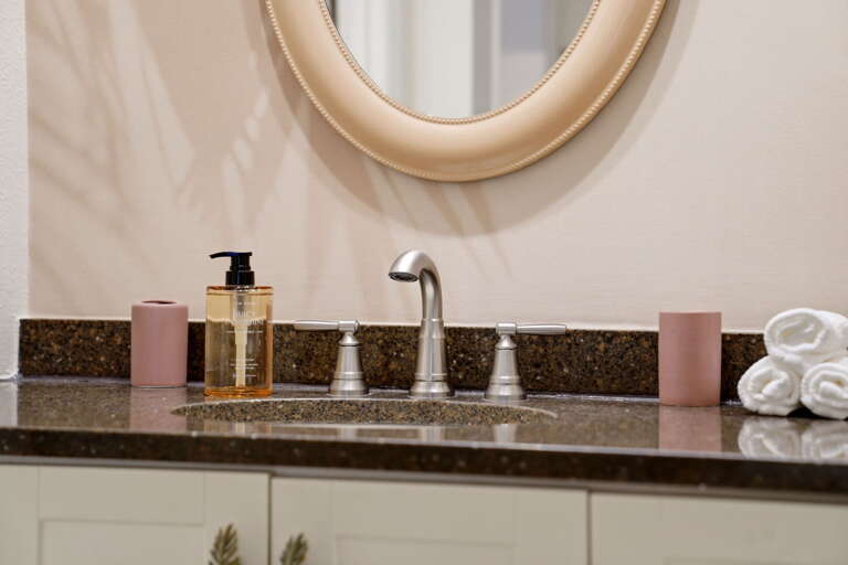 Amber soap, rolled towels, everything in its place. The master vanity runs like a well-stocked hotel bathroom.