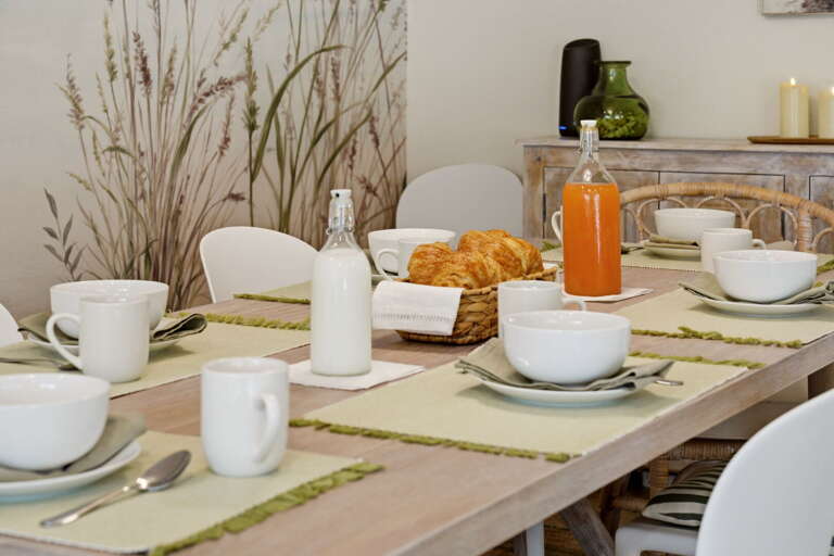 Coffee, croissants, and the whole beach scene in front of you. Breakfast at this table doesn't feel like breakfast anywhere else.