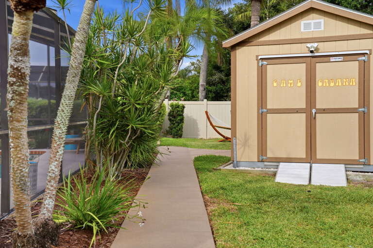 The GAME CABANA building sits right off the pool path — step in to break a sweat, step back to the pool to cool down.