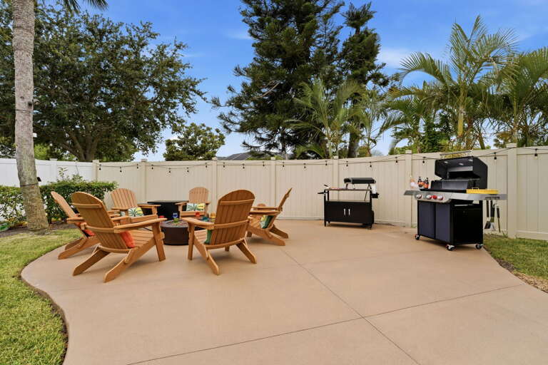A pizza maker, a gas grill, and a fire pit — this patio handles everything from Sunday morning breakfast to late-night s'mores.
