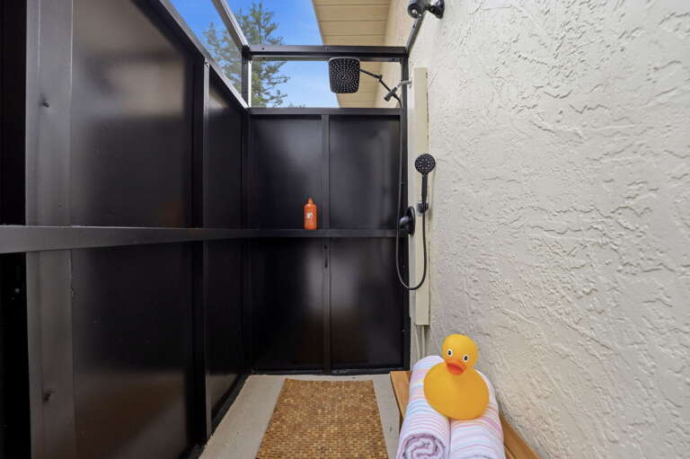 Rinse off after the beach before you even step inside. The outdoor shower handles the saltwater — towels are waiting.