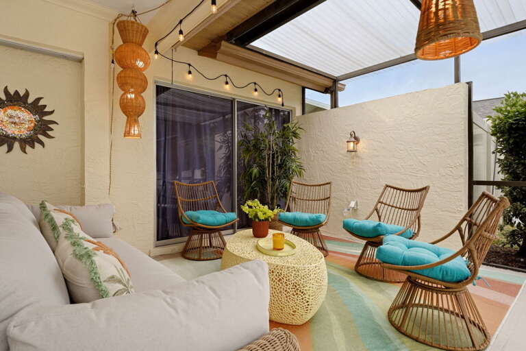 A second seating nook tucked into the covered end of the patio — perfect for the people who want conversation instead of pool time.