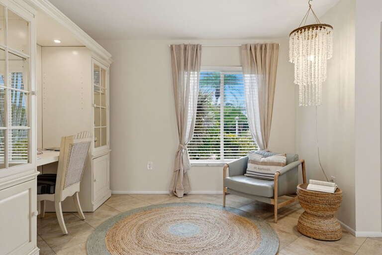 Work-from-vacation is a real option here. The built-in desk, private nook, and palm view out the window make it harder to log off, not easier.