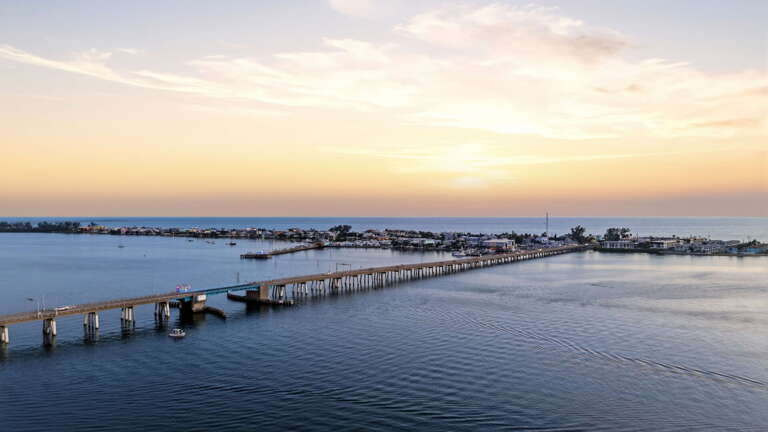 Aerial view of the full Cortez Bridge corridor - the bridge stretches the entire width of the frame from Cortez to Anna Maria Island
