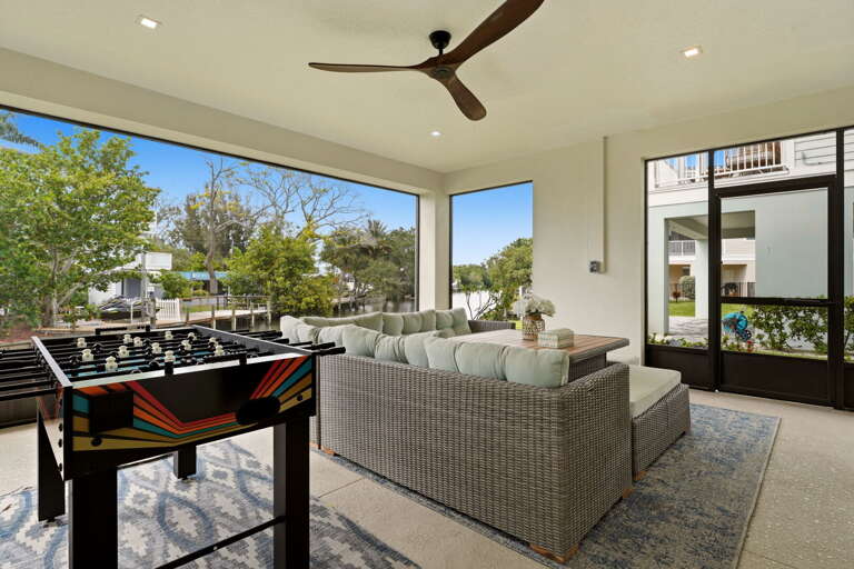 Another angle of the enclosed porch showcases the generous sectional seating arrangement