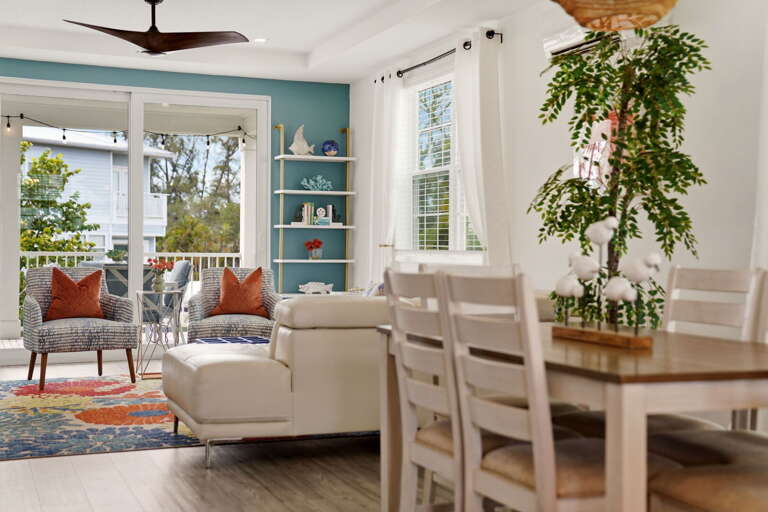 Looking from the dining area into the living space, the open floor plan shines - a seamless flow between dining, living, and the balcony beyond