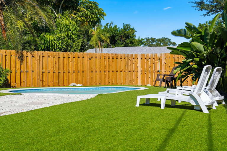 Claim your lounge chair and ignore the world for a few hours. The turf stays cool and the fence keeps everything private.