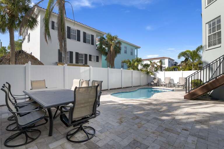 Eat outside under the Florida sky while the pool reflects the late light behind you — this patio is where dinner turns into a two-hour conversation.