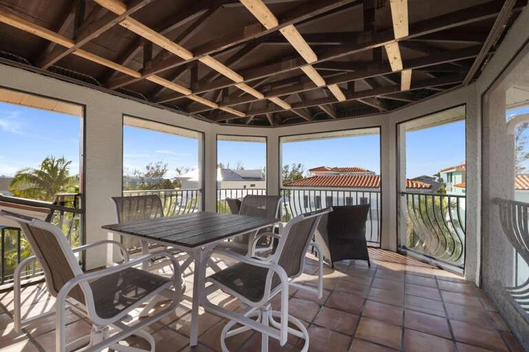 You get the same elevated rooftop views but with shade and a ceiling fan — perfect for morning coffee, a long lunch, or watching the neighborhood wind down.