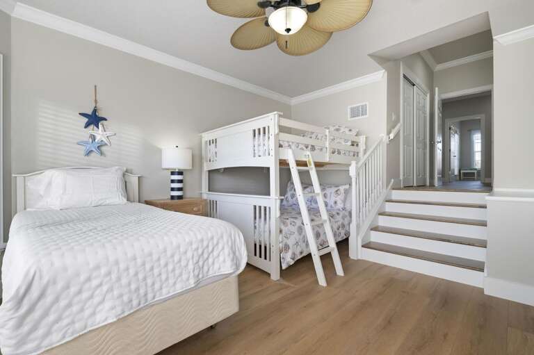 You'll hear the kids claim this room the moment they see it — bunk bed, twin, nautical star decor, and a window that keeps it bright. They won't want to leave.