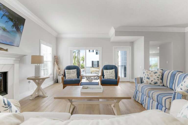 Open the french doors, angle toward the fireplace, and let the breeze through — this is the living room at its best and where evenings wind down on their own.