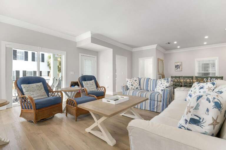 The open layout means you're never cut off from the conversation — rattan swivel chairs face wherever the room is going and the cushions hold their shape.