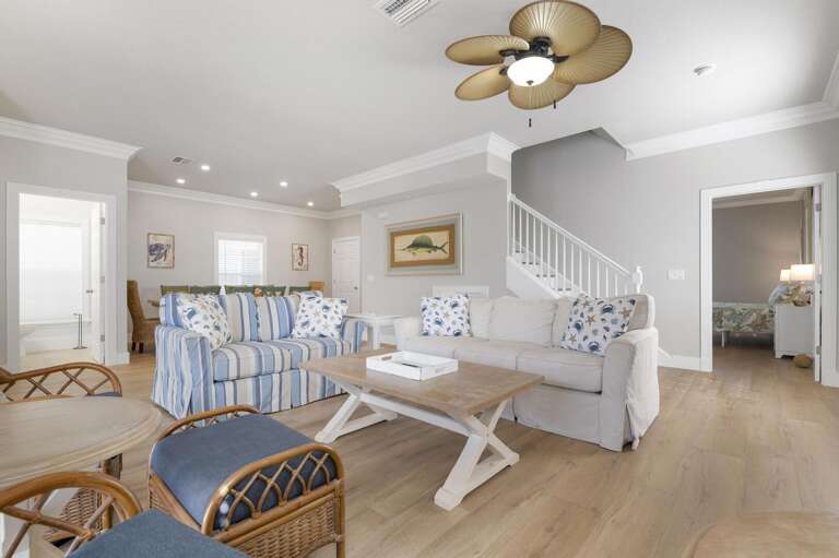 From here you can see the staircase, both sofas, and the whole open floor plan — this house was designed for groups who actually spend time together.