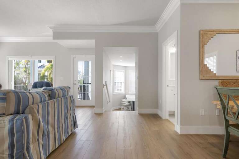 Walk into this end of the house and you'll understand why people linger here — light wood floors, french doors, bright and easy and built for a slow morning.