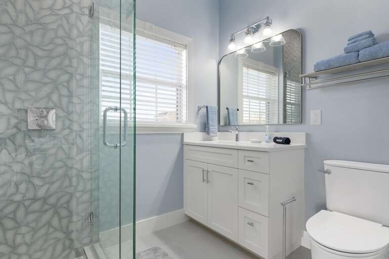 Walk through the room and it opens up — this king bedroom has space to move, flat surfaces to put things down, and a bathroom right through that door.