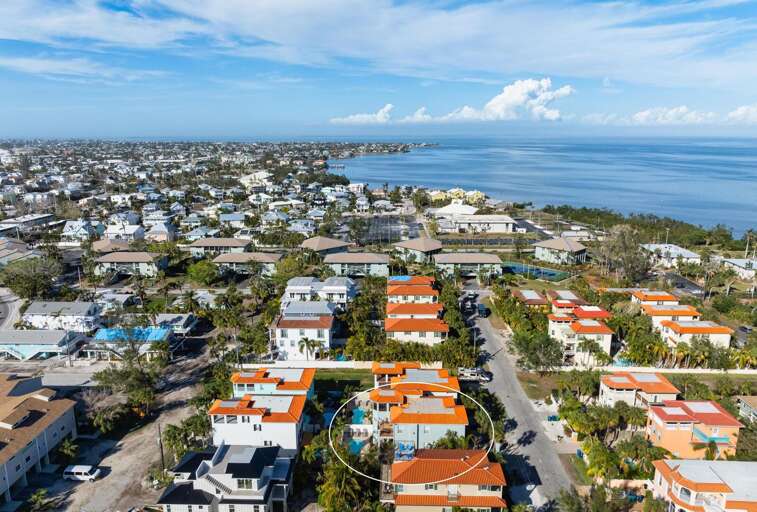 Zoom out and you'll see the bay waterway, the neighborhood streets, and the coastal density of AMI — a small island where the water is never more than a few minutes away.
